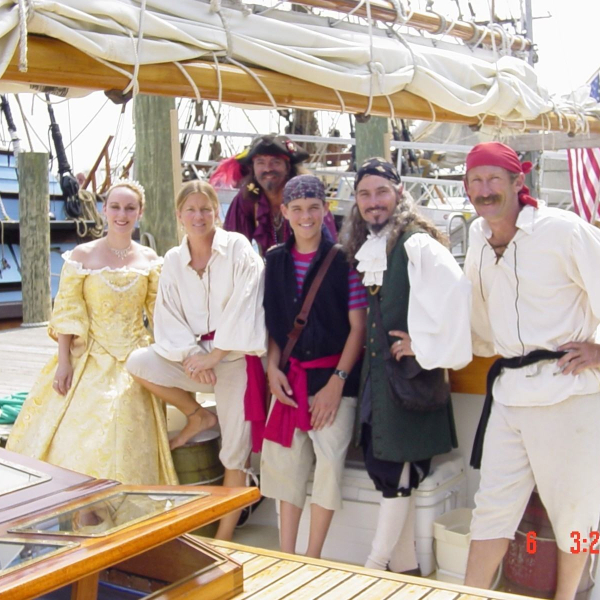 a group of people standing around a table