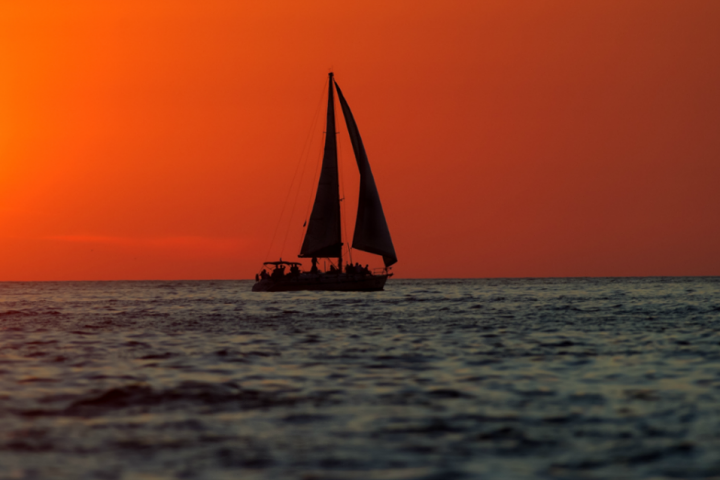 a boat that is sitting in front of a large body of water