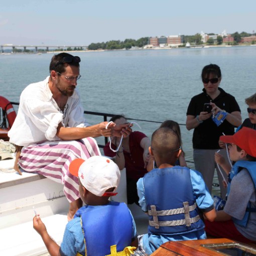 a group of people in a boat on a body of water