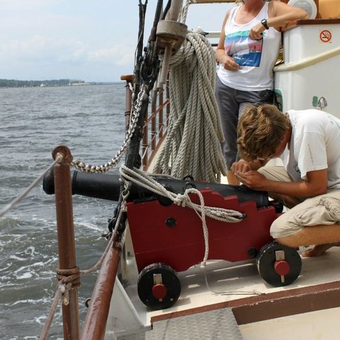 a man sitting on a boat in the water