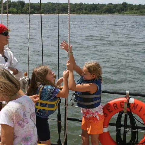 a group of people in a boat on a body of water