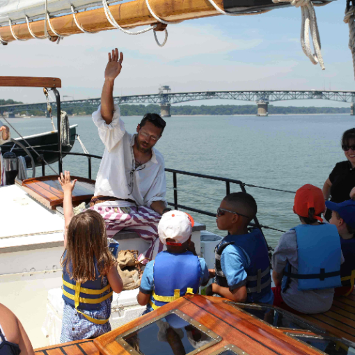 a group of people in a boat on a body of water