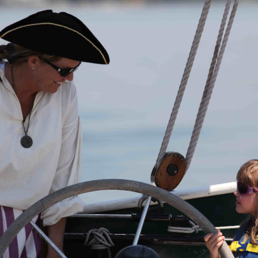 a person standing next to a boat