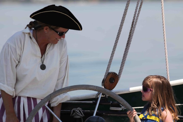 a person standing next to a boat